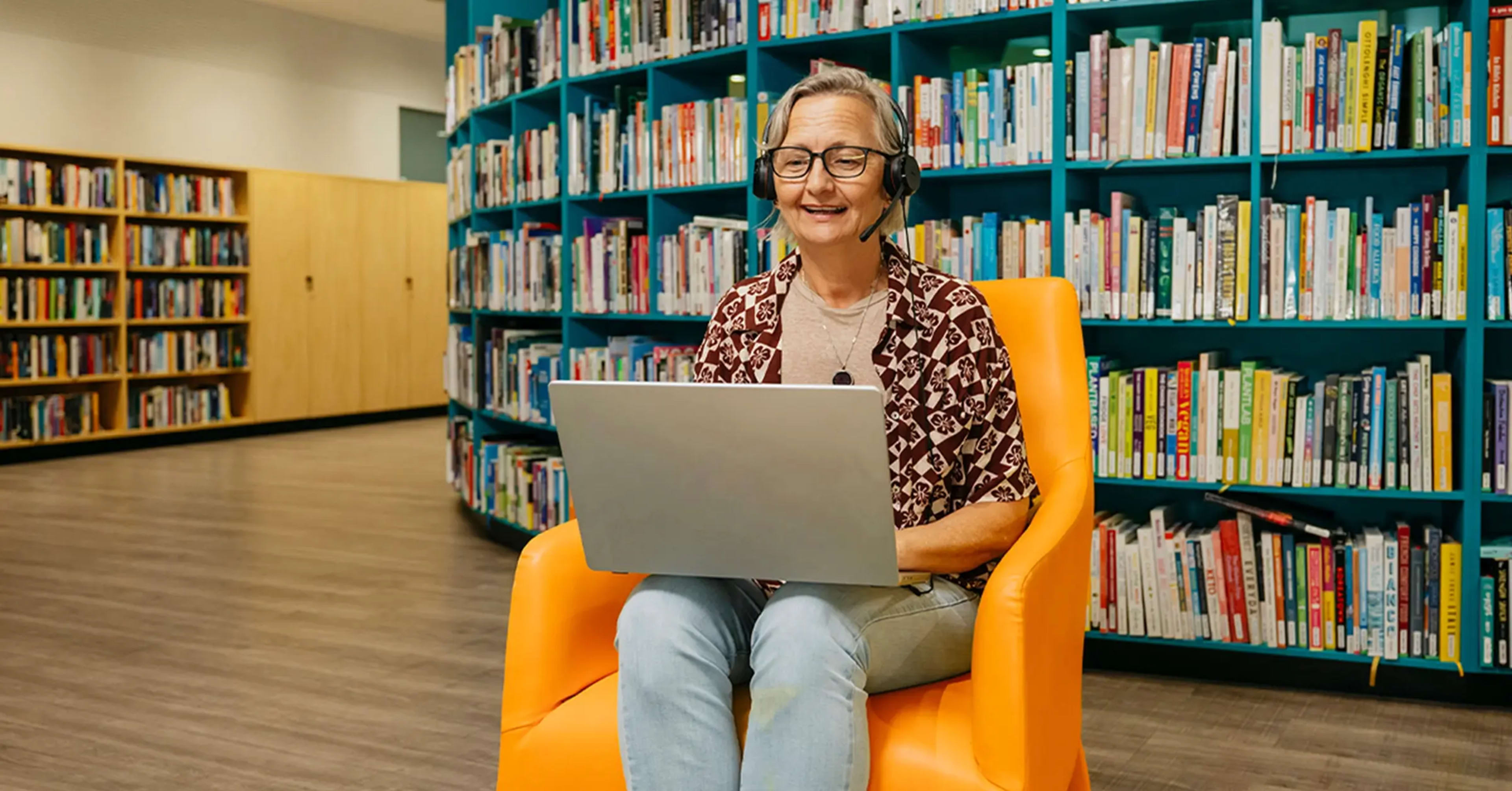 Support coordinator with laptop and headset searches support workers on Mable for their clients.