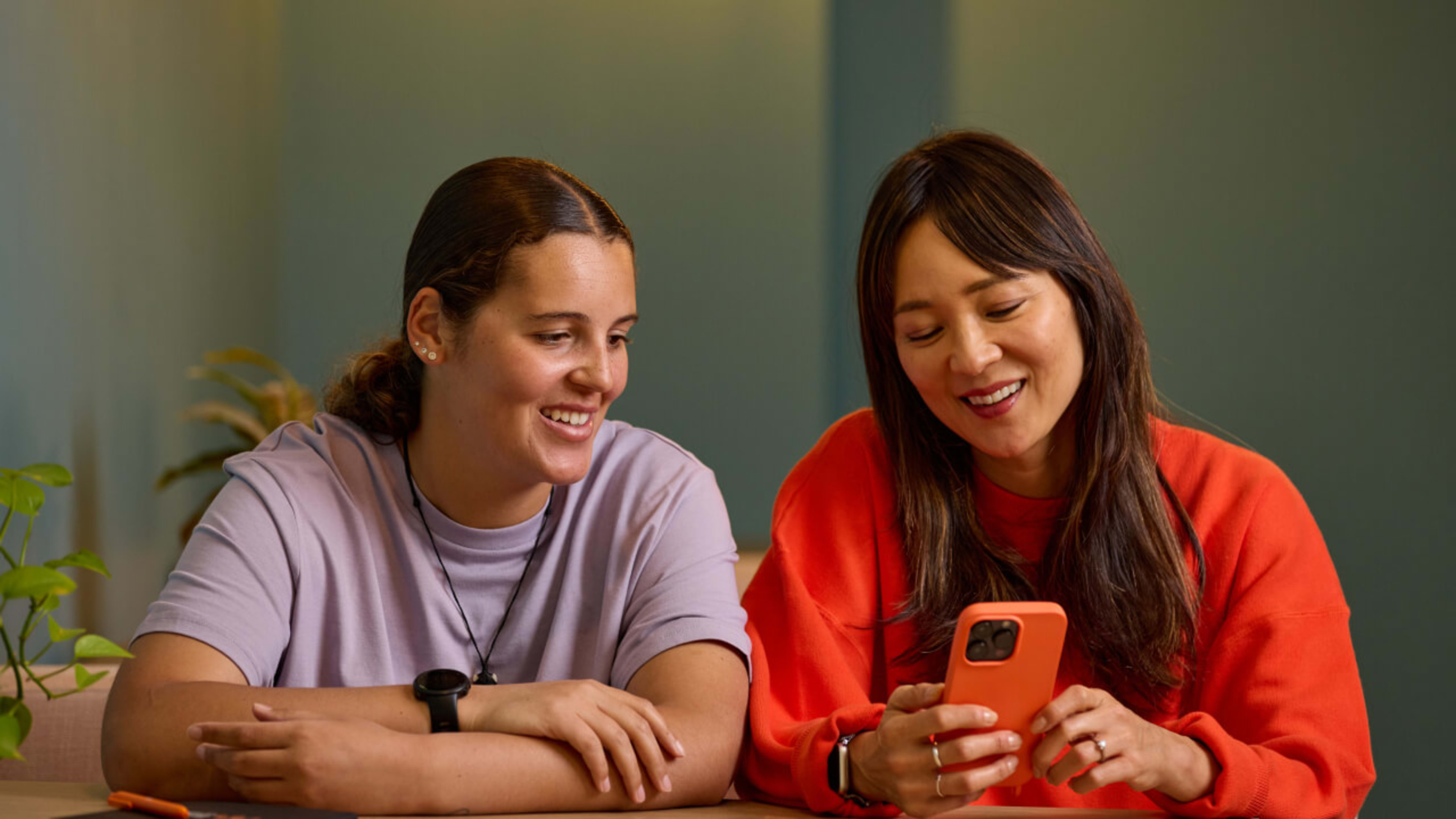 Colleagues collaborate on a mobile phone